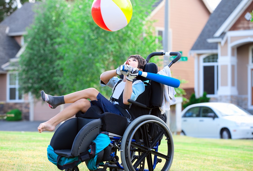 Boy in wheelchair playing baseball