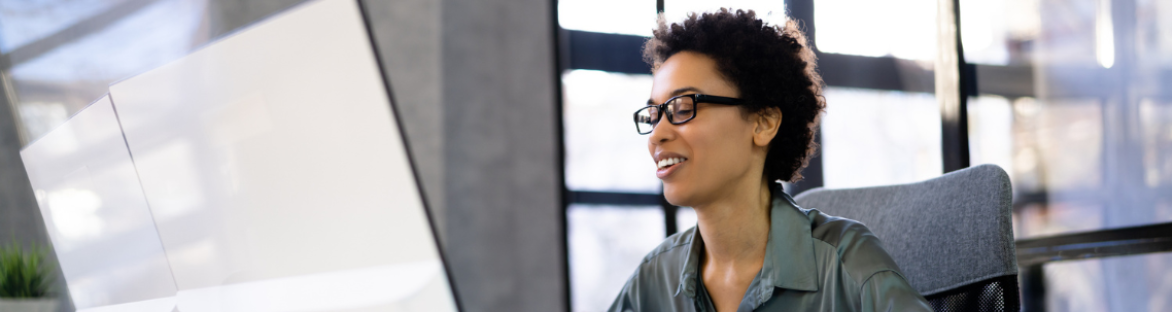 Woman looking at laptop smiling