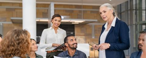 manager standing with employees