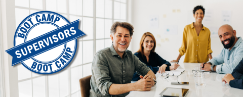 five coworkers seated around table with SBC logo