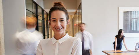 young woman in forefront of busy office
