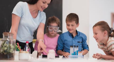 Children and teacher doing science experiment