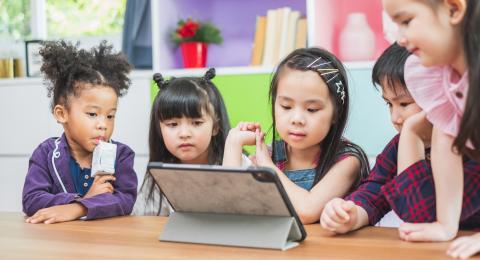 Young students looking at tablet