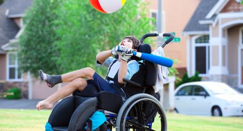 Boy in wheelchair playing baseball