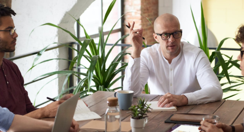 man leading a meeting at conference table