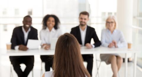 Panel of interviewers smiling at interviewee