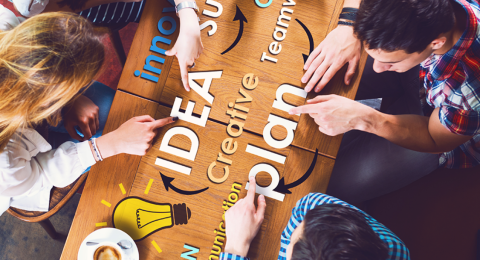 people working on a plan at a table