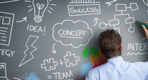 Illustration of businessperson at a blackboard writing out strategy symbols
