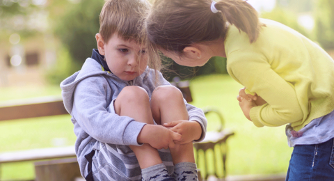 One child consoling another at a playground