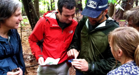 group in forest looking at GPS