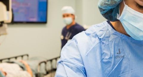 healthcare worker wearing scrubs and a mask