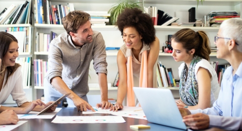 Professionals gathered around a table brainstorming