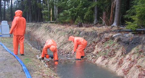 people in rain suits working in stormwater