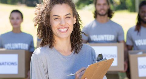 women holding clipboard with volunteers