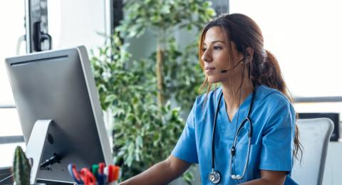 Person with headset and computer monitor