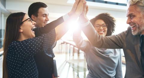 multicultural team giving high fives