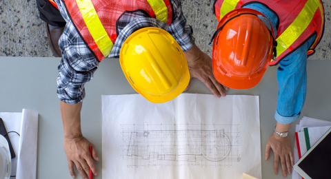 two construction managers looking at a blueprint