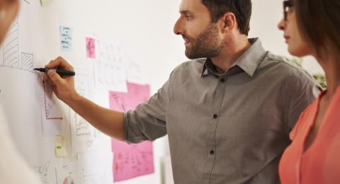 man writing on whiteboard