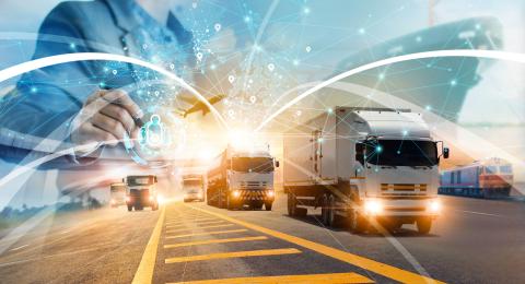 Graphic of trucks and person holding technology