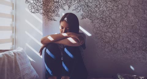 upset woman sitting on bed