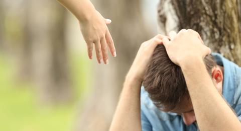 hand reaching out to person in distress