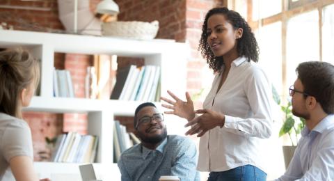 woman standing and sharing in meeting