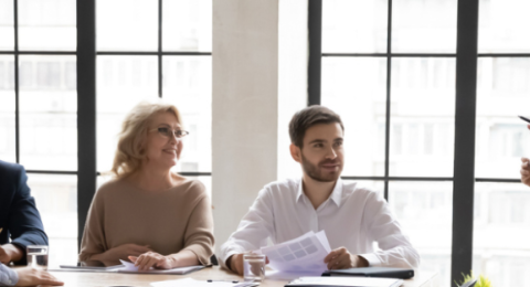 Group of workers sitting in conference room having a discussion