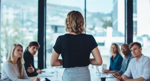 Businessperson giving a presentation at a conference table