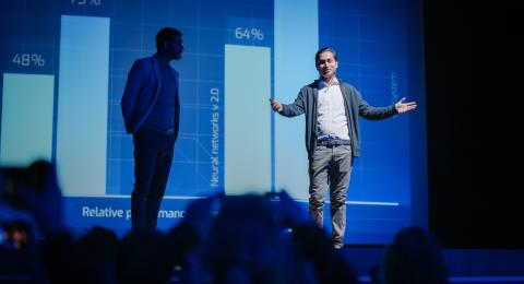 Person in a spotlight on stage presenting business information