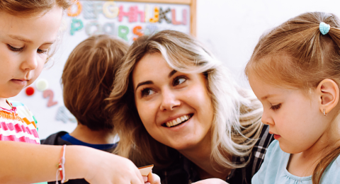 Teacher looking at little girl