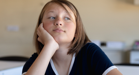 bored female student sitting at desk