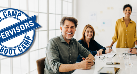 five coworkers seated around table with SBC logo