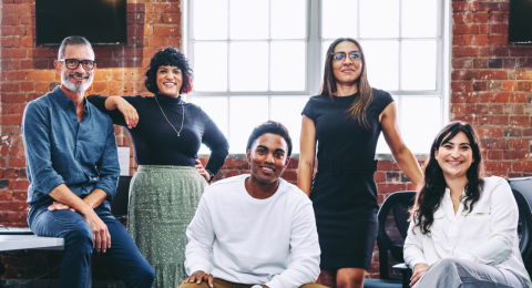 multi generational team of six in office setting