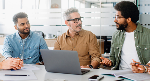 Colleagues engage in exchange of ideas in an office