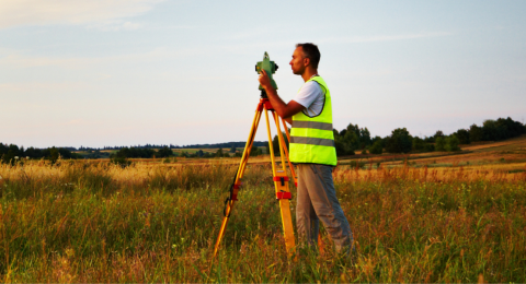 Surveyor making measure on the field