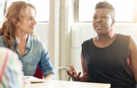 women talking at a table