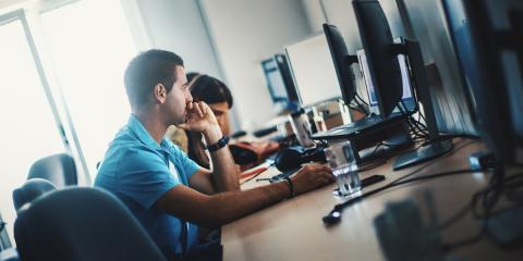 man sitting at computer