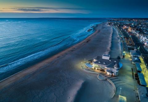 overhead shot of beach and city at twilight