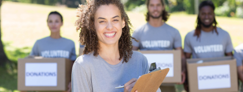 women holding clipboard with volunteers