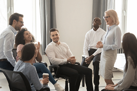 Professionals gathering and talking in a room