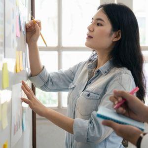 Woman project managing on whiteboard