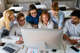 team working around a computer
