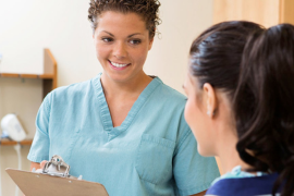 female medical assistant talking to patient