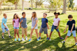 children playing in line on grass